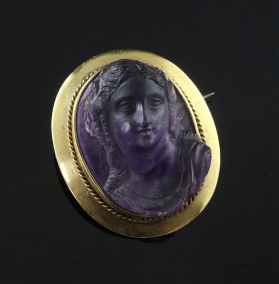 A gold mounted amethyst portrait brooch, 33mm.